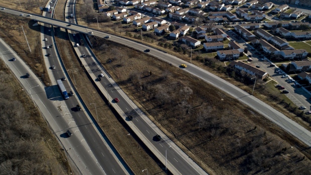 Vehicles travel past homes on the I-94 highway in this aerial photograph taken over Chicago.