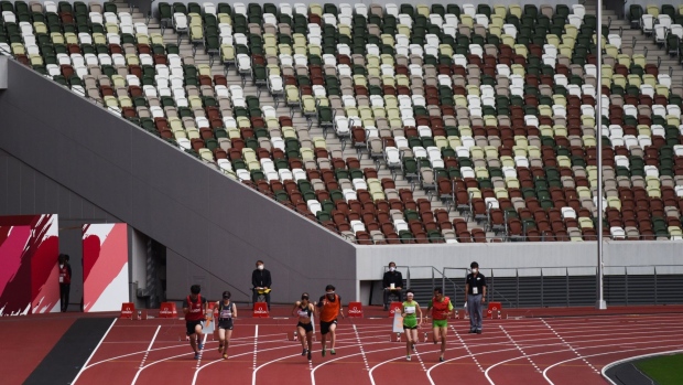 Athletes and their guides compete during a para athletics test event for the Tokyo 2020 Paralympic Games at the National Stadium in Tokyo, Japan, on Tuesday, May 11, 2021. Japan’s government is determined to go ahead with the Olympic and Paralympic events, despite rising infection numbers and parts of the world still struggling to get the pandemic under control.
