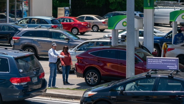 An Uber driver gestures to a line of cars waiting in line at a BP Plc gas station in Kennesaw, Georgia, U.S., on Thursday, May 13, 2021. Five days after a criminal hack shut down deliveries of almost half the gasoline and diesel burned in the eastern U.S., the Atlanta area's reserves of gas and diesel began to plummet.