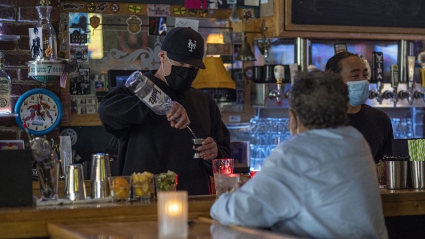 A bartender wearing a protective mask mixes a drink inside a bar in San Francisco, California, U.S., on Thursday, May 6, 2021. San Francisco advanced into the least restrictive tier of Californias color-coded reopening system Tuesday, allowing most businesses to expand capacity, bars to start serving indoors and large gatherings to resume inside and outside. Photographer: David Paul Morris/Bloomberg