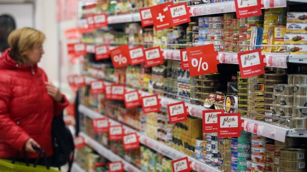 Tinned fish products sit on shelves as a customer browses inside a Victoria supermarket operated by Dixy Group PJSC in Moscow, Russia, on Friday, Oct. 21, 2016. The central bank has warned that its ability to steer inflation is at risk from growing wealth inequality and the disappearance of the middle-income households that are the most sensitive to interest rates and prices. Photographer: Andrey Rudakov/Bloomberg