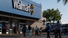 Shoppers walk in front of a Walmart store in San Leandro, California, U.S., on Thursday, May 13, 2021. Walmart Inc. is expected to release earnings figures on May 18.