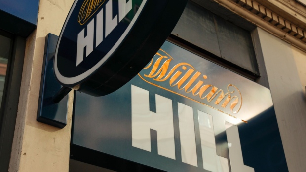 A sign hangs at a William Hill Plc betting shop in London, U.K., on Monday, Sept. 28, 2020. Caesars Entertainment Inc. said William Hill Plc’s board would likely recommend its 2.9 billion-pound ($3.7 billion) takeover offer price, giving it an edge over rival suitor Apollo Global Management Inc. Photographer: Jason Alden/Bloomberg