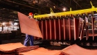 A worker handles newly formed copper cathode sheets in a warehouse at the KGHM Polska Miedz SA copper smelting plant in Glogow, Poland, on Tuesday, March 9, 2021. Nickel extended its plunge from a six-year high after a stock-market slump hurt risk appetite, while copper resumed losses as supply concerns eased. Photographer: Bartek Sadowski/Bloomberg