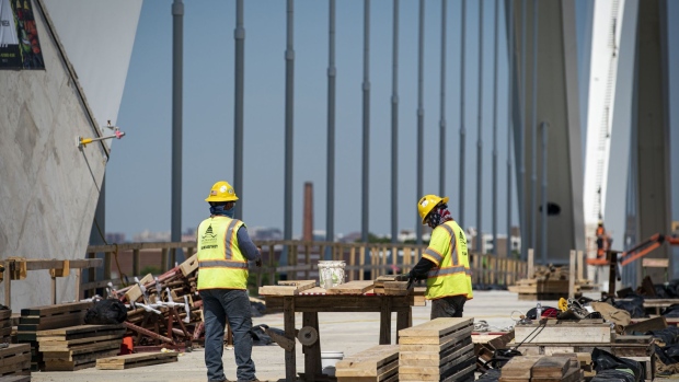 Construction workers on the Frederick Douglass Memorial Bridge in Washington, D.C., U.S., on Wednesday, May 19, 2021. The White House said it was "encouraged" by talks yesterday with Republican senators on a major new infrastructure package, even as lawmakers said the session yielded no agreement on an overall spending figure or on how to pay for it. Photographer: Al Drago/Bloomberg
