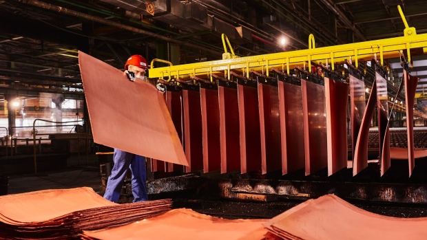 A worker handles newly formed copper cathode sheets in a warehouse at the KGHM Polska Miedz SA copper smelting plant in Glogow, Poland, on Tuesday, March 9, 2021. Nickel extended its plunge from a six-year high after a stock-market slump hurt risk appetite, while copper resumed losses as supply concerns eased.