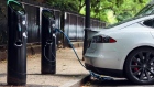 A charging plugs connects a Tesla Inc. Model S electric vehicle (EV) to a charging station in London, U.K., on Friday, Aug. 4, 2017. The U.K. government plans to invest more than 800 million pounds ($1 billion) in new driverless and zero-emission vehicle technology as it seeks to boost its economy while leaving the European Union. Photographer: Bloomberg/Bloomberg