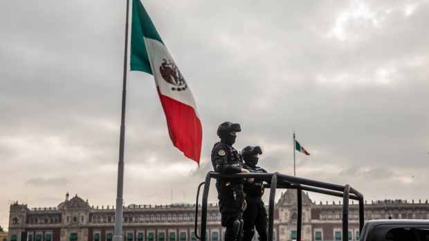 Police officers stand guard near Mexico City Mayor Claudia Sheinbaum's office in Mexico City, Mexico, on Thursday, Sep. 17, 2020. Mexico City released excess death figures for 2020 for the first time Wednesday showing that 30,462 more people have died through August than an average of previous years as the coronavirus pandemic pummels the megacity of 18 million. Photographer: Alejandro Cegarra/Bloomberg