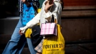 A pedestrian carries Victoria's Secret Stores LLC and Forever 21 Inc. shopping bags while walking along a street in New York, U.S., on Wednesday, Sept. 25, 2019. Bloomberg is scheduled to release consumer comfort figures on October 3. Photographer: Demetrius Freeman/Bloomberg