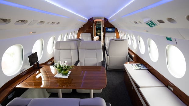 The interior of a Dassault Aviation SA Falcon 8X private jet is seen during the Singapore Airshow at the Changi Exhibition Centre in Singapore, on Tuesday, Feb. 11, 2020. Plane makers and airlines are exploring new designs to reduce fuel burn and cut carbon emissions in a warming climate. Blending the wings with the fuselage to cut drag is one of several possible solutions. Photographer: SeongJoon Cho/Bloomberg