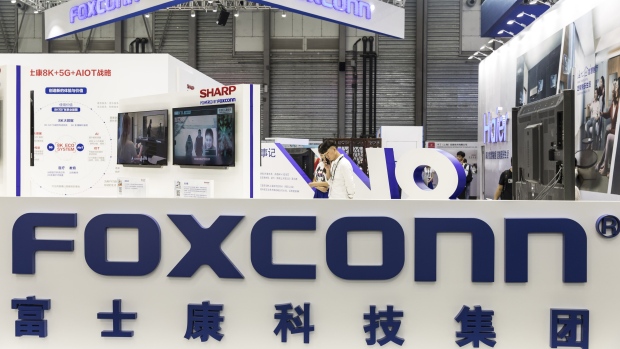 Signage for Foxconn Technology Group is displayed at the company's booth at the CES Asia 2018 show in Shanghai, China, on Wednesday, June 13, 2018. The show runs through June 15. Photographer: Qilai Shen/Bloomberg
