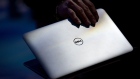 An attendee opens a Dell Ultrabook at the International Consumer Electronics Show (CES) in Las Vegas, Nevada, U.S.