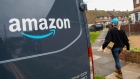An Amazon.com Inc. delivery driver carries a customer order