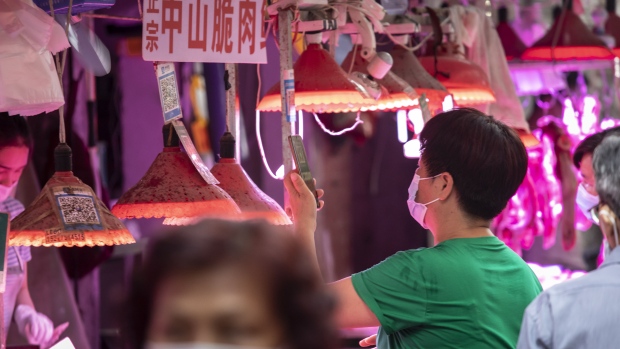 A customer uses a mobile phone to scan a QR code to make a digital payment at an open-air market in Guangzhou, China, on Monday, May 24, 2021. China's central bank has sought to clarify that it won't let the yuan strengthen too much, too quickly, as mixed signals from officials underline the challenges presented by a currency trading near a three-year high. Photographer: Qilai Shen/Bloomberg