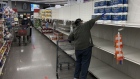 WHEATON, MARYLAND - APRIL 16: A customer reaches for one of the last packages of toilet paper after a panic over supplies. 