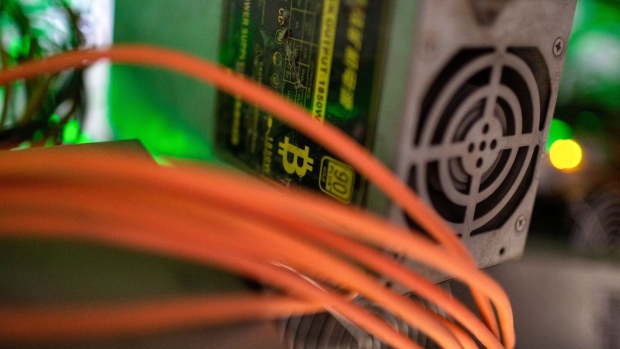 Network cables run alongside a power supply unit for a mining rig at the CryptoUniverse cryptocurrency mining farm in Nadvoitsy, Russia, on Thursday, March 18, 2021. The rise of Bitcoin and other cryptocurrencies has prompted the greatest push yet among central banks to develop their own digital currencies. Photographer: Andrey Rudakov/Bloomberg