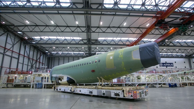 The assembled fuselage of an Airbus A320 narrow-body twin-engine passenger jet airliner is wheeled from the Airbus SE factory floor in Hamburg, Germany.