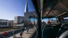 Commuters walk across London Bridge against a backdrop of The Shard in London, U.K., on Thursday, May 27, 2021. More than half of workers in London's financial districts may now be traveling back into the office, the most since lockdown measures began easing in the U.K., according to rising sales of tuna baguettes and lattes. Bloomberg