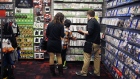 An employee assists customers inside a GameStop store in Louisville, Kentucky. Photographer: Luke Sharrett/Bloomberg