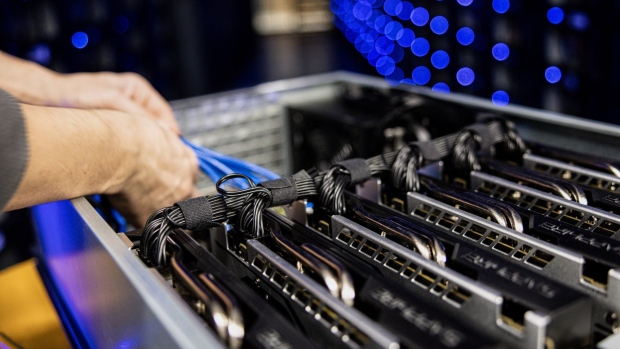 An engineer arranges cables in a draw housing six Sapphire Technology Ltd. AMD graphics processing units (GPU) used to mine the Ethereum and Zilliqa cryptocurrencies at the Evobits crypto farm in Cluj-Napoca, Romania, on Wednesday, Jan. 22, 2021. The world’s second-most-valuable cryptocurrency, Ethereum, rallied 75% this year, outpacing its larger rival Bitcoin. Photographer: Akos Stiller/Bloomberg
