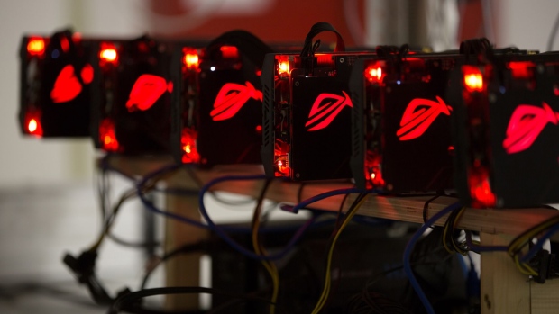 Red lights illuminate cryptocurrency mining rig units at the SberBit mining 'hotel' in Moscow, Russia, on Saturday, Dec. 9, 2017. Futures on the world’s most popular cryptocurrency surged as much as 26 percent in their debut session on Cboe Global Markets Inc.'s exchange, triggering two temporary trading halts designed to calm the market. Photographer: Andrey Rudakov/Bloomberg