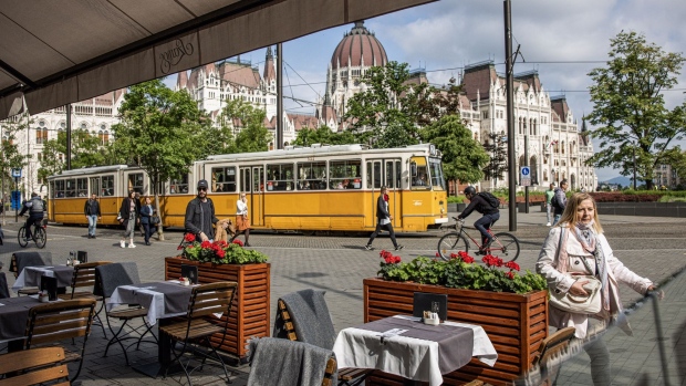 A tram travels past an empty restaurant terrace in Budapest, Hungary, on Tuesday, May 25, 2021. Hungary is moving closer to the European Union’s first major increase in interest rates this year, with policy makers poised to flag the start of a monetary-tightening cycle next month.