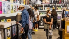 Shoppers wearing protective masks browse at an Amoeba Music store in Los Angeles. Photographer: Roger Kisby/Bloomberg