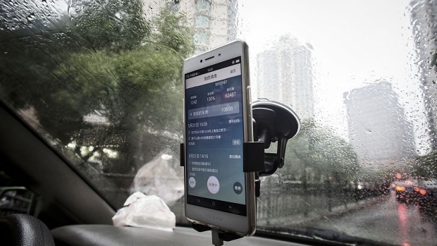 The Didi Chuxing application is displayed on a smartphone screen onboard a vehicle in Shanghai, China, on Sunday, May 22, 2016. Philippe Laffont's Coatue Management LLC, which manages more than $7 billion, has backed China's biggest ride-hailing app Didi Chuxing as it competes with Uber Technologies Inc.