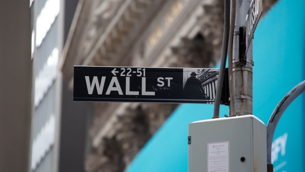 A Wall Street street sign is displayed in front of the New York Stock Exchange (NYSE) in New York, U.S., on Thursday, Feb. 11, 2021. Signify Health Inc. opened trading at $32 after its $564 million IPO priced at $24 per share, above its $20 to $21 offering range. Photographer: Michael Nagle/Bloomberg