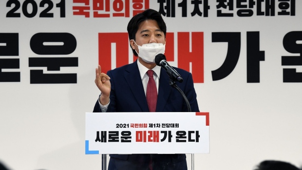 SEOUL, SOUTH KOREA - JUNE 11: Lee Jun-seok, waves patry's flag as he was elected as the chairman of the main opposition People Power Party at the party's national convention on June 11, 2021 in Seoul, South Korea. Lee Jun-seok, a 36-year-old politician with no experience as a lawmaker, won a victory to take the helm of the main opposition People Power Party (PPP) as the youngest-ever leader of a mainstream party in modern South Korean politics. (Photo by Kim Min-Hee - Pool/Getty Images)