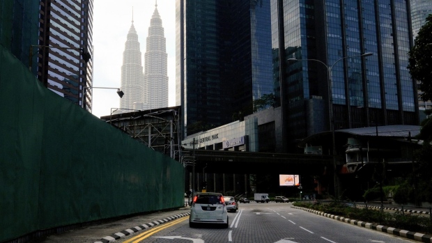 Vehicles travel along a near-empty road in Kuala Lumpur, Malaysia, on Tuesday, June 1, 2021. Malaysia unveiled a 40 billion ringgit ($9.7 billion) package to help people and companies through the two-week nationwide lockdown that began today.