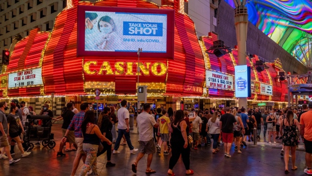 Pedestrians walk through downtown Las Vegas on May 1. Photographer: Roger Kisby/Bloomberg