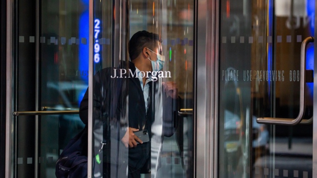 A person wearing a protective mask enters JPMorgan Chase & Co. headquarters in New York, U.S., on Monday, Sept. 21, 2020. JPMorgan CEO Dimon has made the case for a broader return, saying his firm has seen "alienation" among younger workers and that an extended stretch of working from home could bring long-term economic and social damage. Photographer: Michael Nagle/Bloomberg
