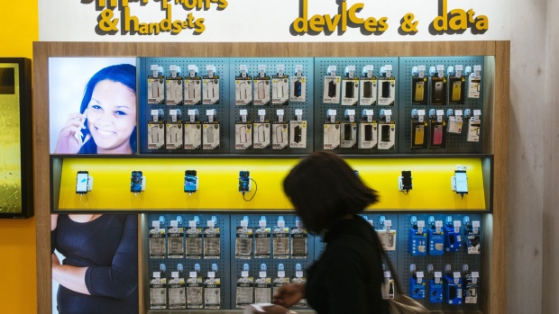 A customer passes a display of mobile phone devices and data accessories in an MTN Group Ltd. telecommunications store at the Clearwater Mall in Johannesburg, South Africa, on Thursday, Aug. 3. 2017. MTN Group Ltd. said a Nigerian listing that it agreed to as part of a $1 billion regulatory fine was on track and would take place within the next six to 12 months. Photographer: Waldo Swiegers/Bloomberg