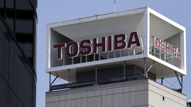 Signage for Toshiba Corp. displayed at the company's headquarters in Tokyo, Japan, on Wednesday, April 7, 2021. Toshiba surged its daily limit of 18% after confirming it received an initial buyout offer from CVC Capital Partners, setting the stage for potentially the largest private equity-led acquisition in years.