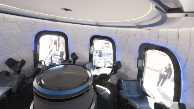 The interior the high fidelity crew capsule mock up of the Blue Origin LLC New Shepard system sits on display during the Space Symposium in Colorado Springs, Colorado, U.S., on Wednesday, April 5, 2017. Jeff Bezos, chief executive officer of Amazon.com Inc. and founder of Blue Origin, has been reinvesting money he made at Amazon since he started his space exploration company more than a decade ago, and has plans to launch paying tourists into space within two years. Photographer: Matthew Staver/Bloomberg