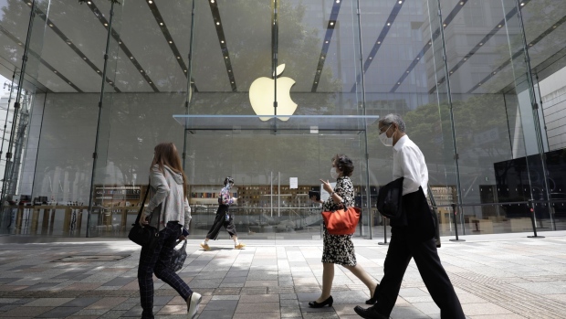 Pedestrians wearing protective masks walk past an Apple Inc. store in the Omotesando district of Tokyo, Japan, on Wednesday, June 3, 2020. Shuttered after the coronavirus outbreak forced a series of restrictive measures across the country, Apple reopens its flagship stores in Japan on Wednesday, bringing its physical retail network back online in one of its biggest markets. Photographer: Kiyoshi Ota/Bloomberg