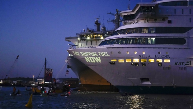 Demonstrators illuminate a message on the Silja Euripa cruise ship, chartered by Devon and Cornwall police as acommodation for their officers during the G7 Summit, in Falmouth, England on June 12. Photographer: Hugh Hastings/Getty Images