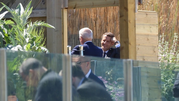Emmanuel Macron, France's president, right, speaking with U.S. President Joe Biden, left, on day two of the Group of Seven leaders summit in Carbis Bay, U.K., on Saturday, June 12, 2021. U.K. Prime Minister Boris Johnson will give leaders a beachside welcome, formally kicking off three days of summitry along the English coast after meeting U.S. President Joe Biden for the first time on Thursday.