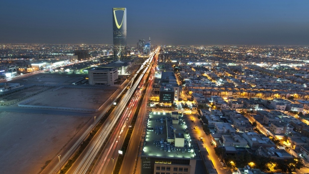 The Kingdom Tower stands illuminated at night in Riyadh, Saudi Arabia. The government is ploughing oil wealth into projects to expand airports, build roads and real estate, and enhance production of petrochemicals and aluminum.