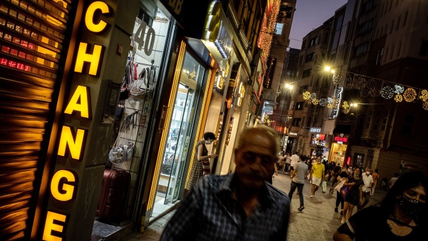 ISTANBUL, TURKEY - JULY 29: People walk past a currency exchange office on July 29, 2020 in Istanbul, Turkey. The Turkish Lira remains under pressure after briefly trading at a record low against the euro of 8.17 on Tuesday amid investor concerns around Turkey's foreign denomination debt and potential EU sanctions. (Photo by Chris McGrath/Getty Images) Photographer: Chris McGrath/Getty Images Europe