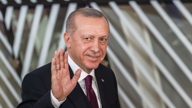 Recep Tayyip Erdogan, Turkey's president, gestures as he arrives ahead of talks in Brussels, Belgium, on Monday, March 9, 2020. Ahead of high-level meetings in Brussels Monday, Erdogan urged Greece to open its borders to refugees, a call likely to further stir tensions with the EU as it grapples with the damage unleashed by the spread of the deadly and unpredictable coronavirus.
