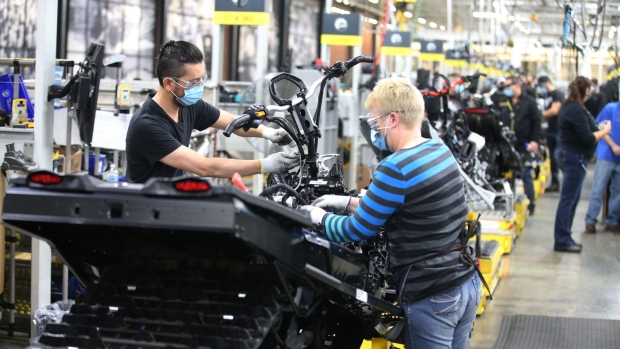 Workers wearing protective masks assemble a Ski-Doo brand snowmobile at a BRP manufacturing facility in Valcourt, Quebec, Canada, on Wednesday, Oct. 28, 2020. BRP Inc. says production shutdowns depleted its inventory and dragged down revenues in its second quarter, but rising demand buoyed profits as fun-seekers turned to power sports for pandemic recreation, The Toronto Star reported.