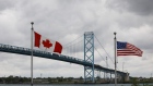 Canadian and American flags fly near the Windsor, Ontario entrance to the Ambassador Bridge connecting Canada to the U.S. last month.