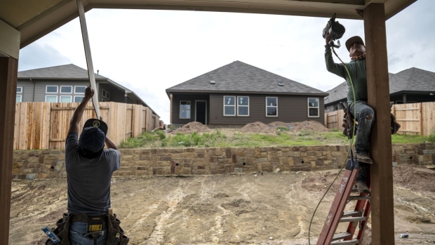 A contractor works on a house under construction at a KB Home development in Gibsonton, Florida, U.S., on Thursday, May 24, 2018. Home prices in 20 U.S. cities climbed more than forecast in March, driven by rising demand and a lack of inventory, according to S&P CoreLogic Case-Shiller data released Tuesday.