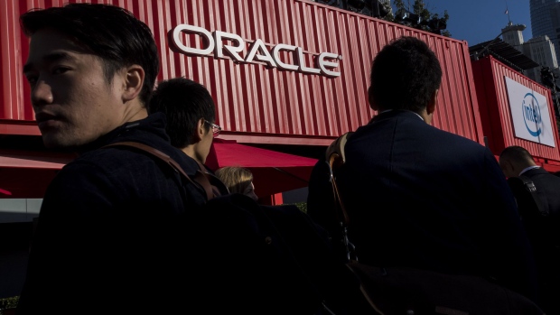 Attendees wait in line to enter the Moscone Center North building during the Oracle OpenWorld 2017 conference in San Francisco, California, U.S., on Tuesday, Oct. 3, 2017. Oracle Corp. plans to pay its leaders more than $100 million each in fiscal 2018, an increase of about 150 percent, as it rips a page from Tesla Inc.\'s playbook to change its executive-compensation practices in response to investor complaints. Photographer: David Paul Morris/Bloomberg