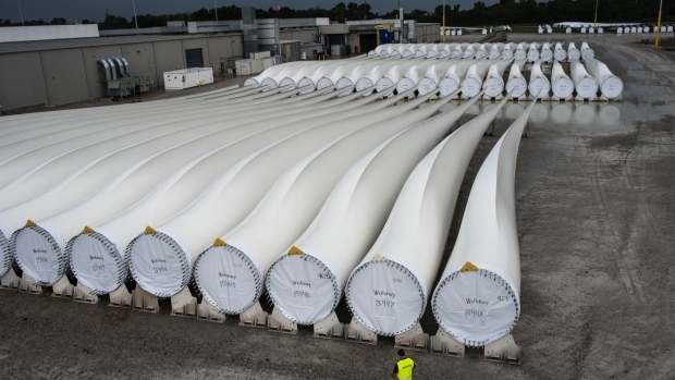 A worker walks along finished blades awaiting transport at the Siemens AG turbine blade plant in Fort Madison, Iowa, U.S., on Wednesday, Aug. 20, 2014. The U.S. Export-Import Bank agreed to lend $65 million for Peruvian wind farms that will use Siemens AG turbines made in Fort Madison and at another Siemens plant in Kansas. Photographer: Timothy Fadek/Timothy Fadek / Bloomberg News