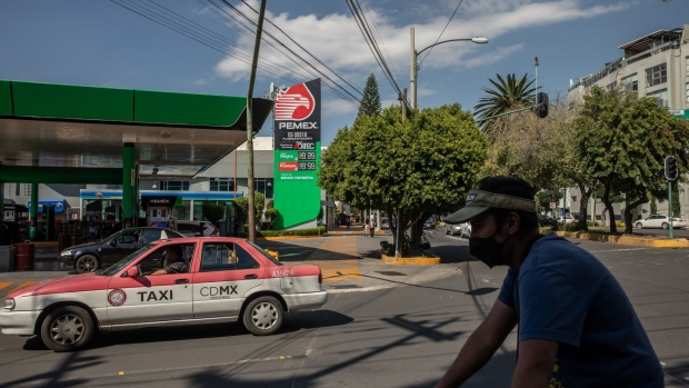 A taxi cap passes in front of a Petroleos Mexicanos (Pemex) gas station in Mexico City, Mexico, on Thursday, Oct. 1, 2020. Mexican President Andres Manuel Lopez Obrador vowed to restore the national oil company to its former glory. Instead, Petroleos Mexicanos is drowning in debt, its oil output is declining, and now it appears to be losing fuel market share in its own backyard. Photographer: Alejandro Cegarra/Bloomberg