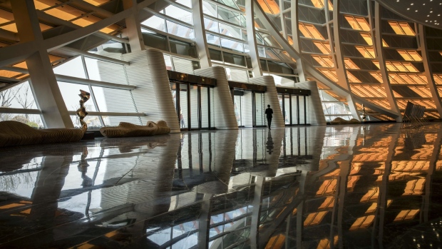 A man walks through the foyer of the Grand Theater at the Dalian Wanda Group Co. Oriental Movie Metropolis film production hub in Qingdao, China, on Tuesday, April 17, 2018. Wanda, a real-estate, retail and entertainment conglomerate, is opening its doors to an audacious 50 billion yuan ($7.9 billion) world-class film production hub, called the Oriental Movie Metropolis, or Dong Fang Ying Du. Photographer: Qilai Shen/Bloomberg