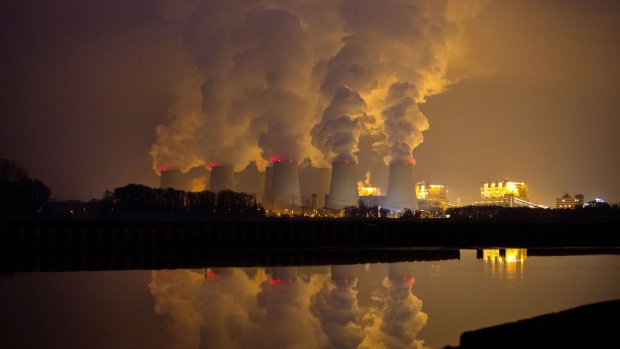 Chimneys emit vapor at Jaenschwalde lignite power plant, operated Vattenfall AB, at dusk in Peitz, Germany.